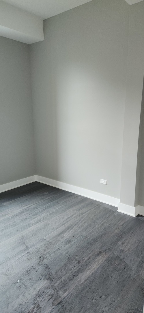 1023 East 45th Street, Unit 2 Chicago, IL 60653 - Photo 8 of 12 a view of an empty room and wooden floor