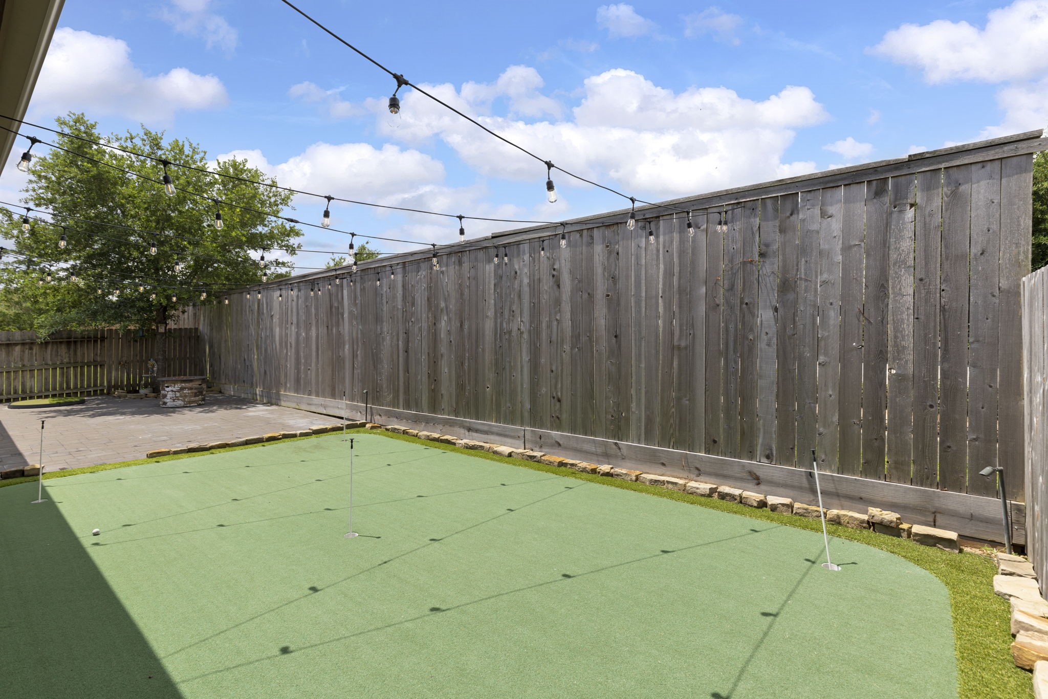 23911 Augusta Falls Lane Spring, TX 77389 - Photo 38 of 40 a view of a backyard with a barbeque and wooden fence