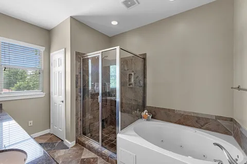 a bathroom with a bathtub and a shower