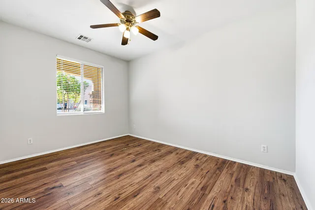 a view of a livingroom with wooden floor and white walls