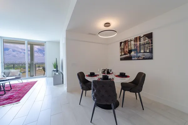 a view of a dining room with furniture and a large window