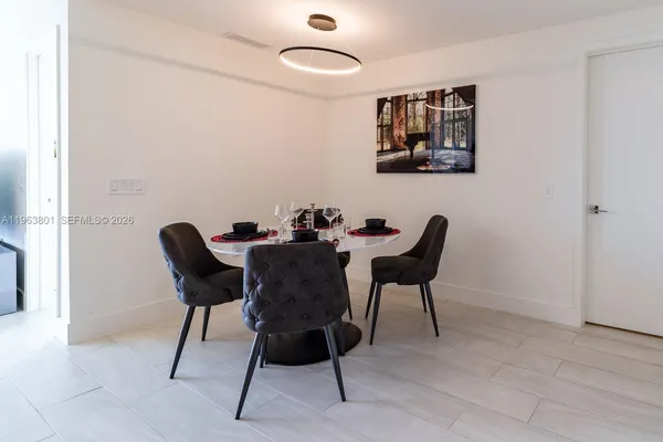 a dining room with furniture and a window