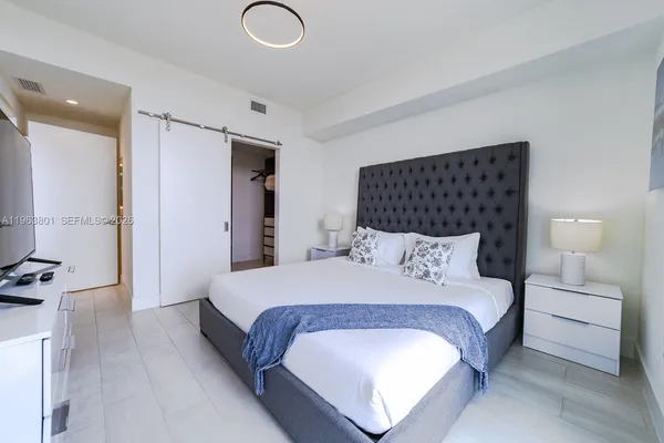 a bedroom with a bed and closet