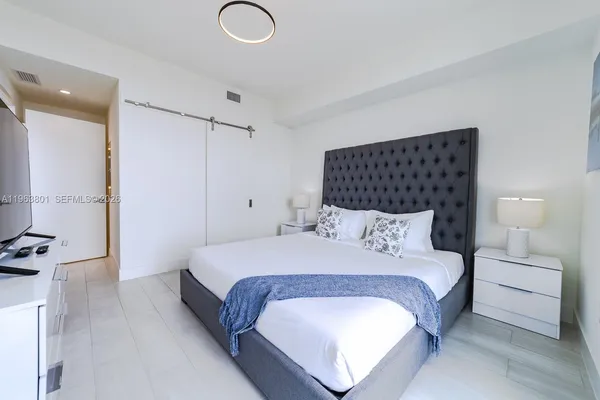 a bedroom with a bed and a night stand