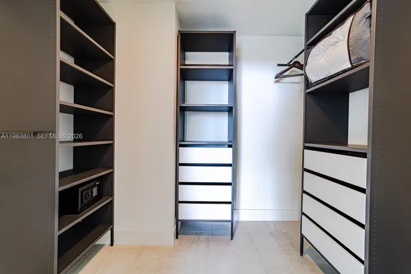 a view of walk in closet with empty racks