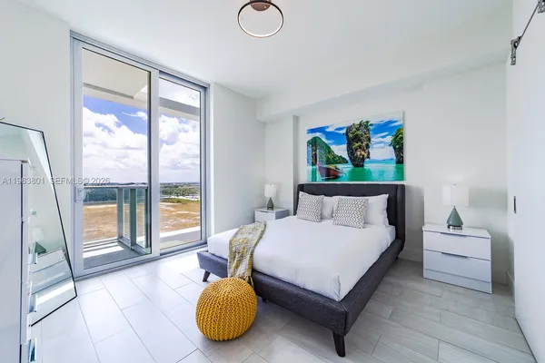 a bedroom with a bed and glass window