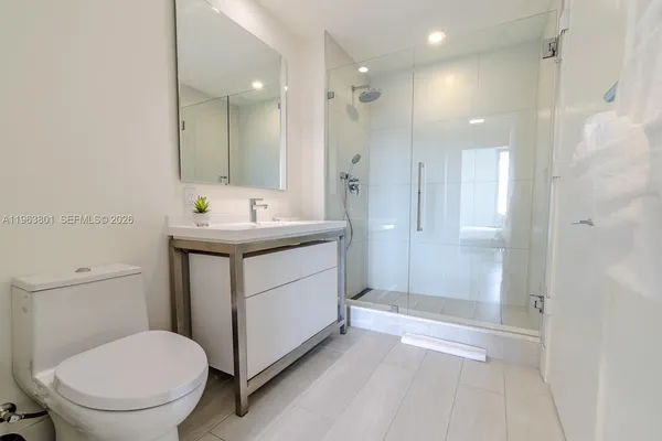 a bathroom with a sink toilet and shower