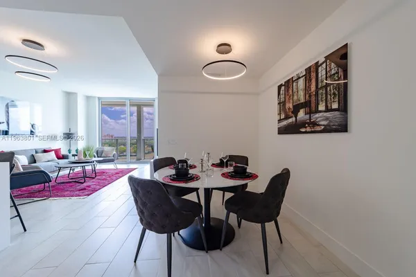 a dining room with furniture and window