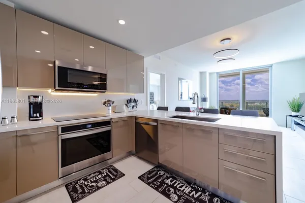 a kitchen with a sink stainless steel appliances and cabinets