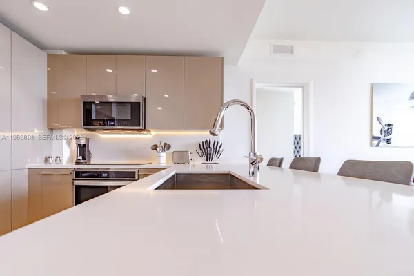 a kitchen with sink refrigerator and stove
