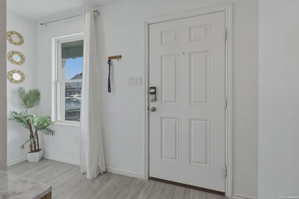 a view of an entryway with wooden floor