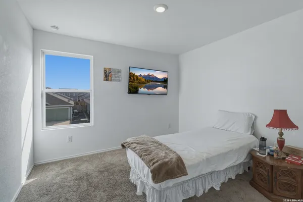 a bedroom with a bed and a painting on the wall