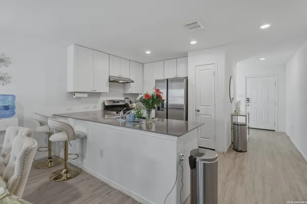 a kitchen with a sink stainless steel appliances and cabinets