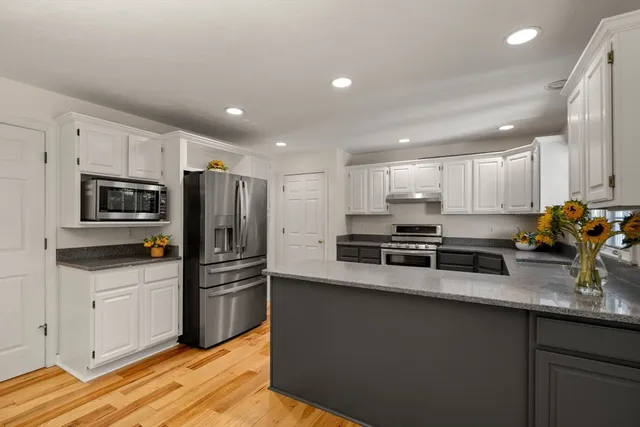 a bathroom with a granite countertop sink a toilet and a mirror