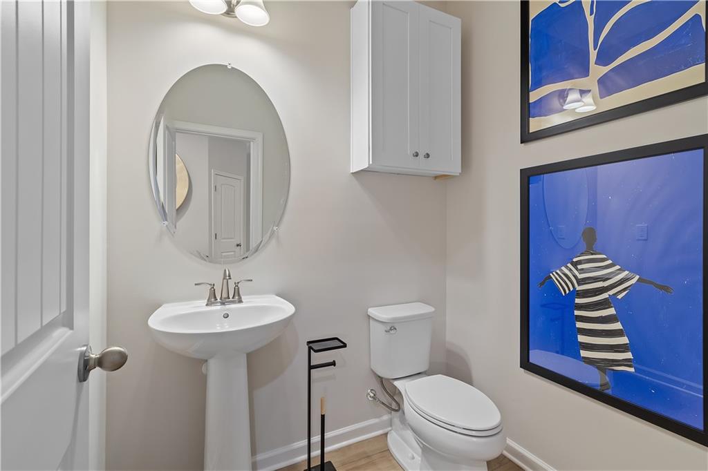 8203 Tiger Way Riverdale, GA 30296 - Photo 4 of 37 a bathroom with a toilet sink and mirror