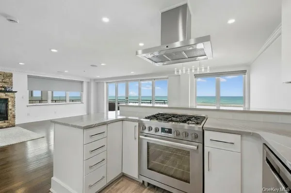 a kitchen with stainless steel appliances a stove a sink and a refrigerator