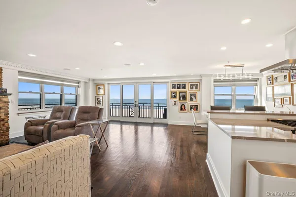 a living room with furniture wooden floor and a large window