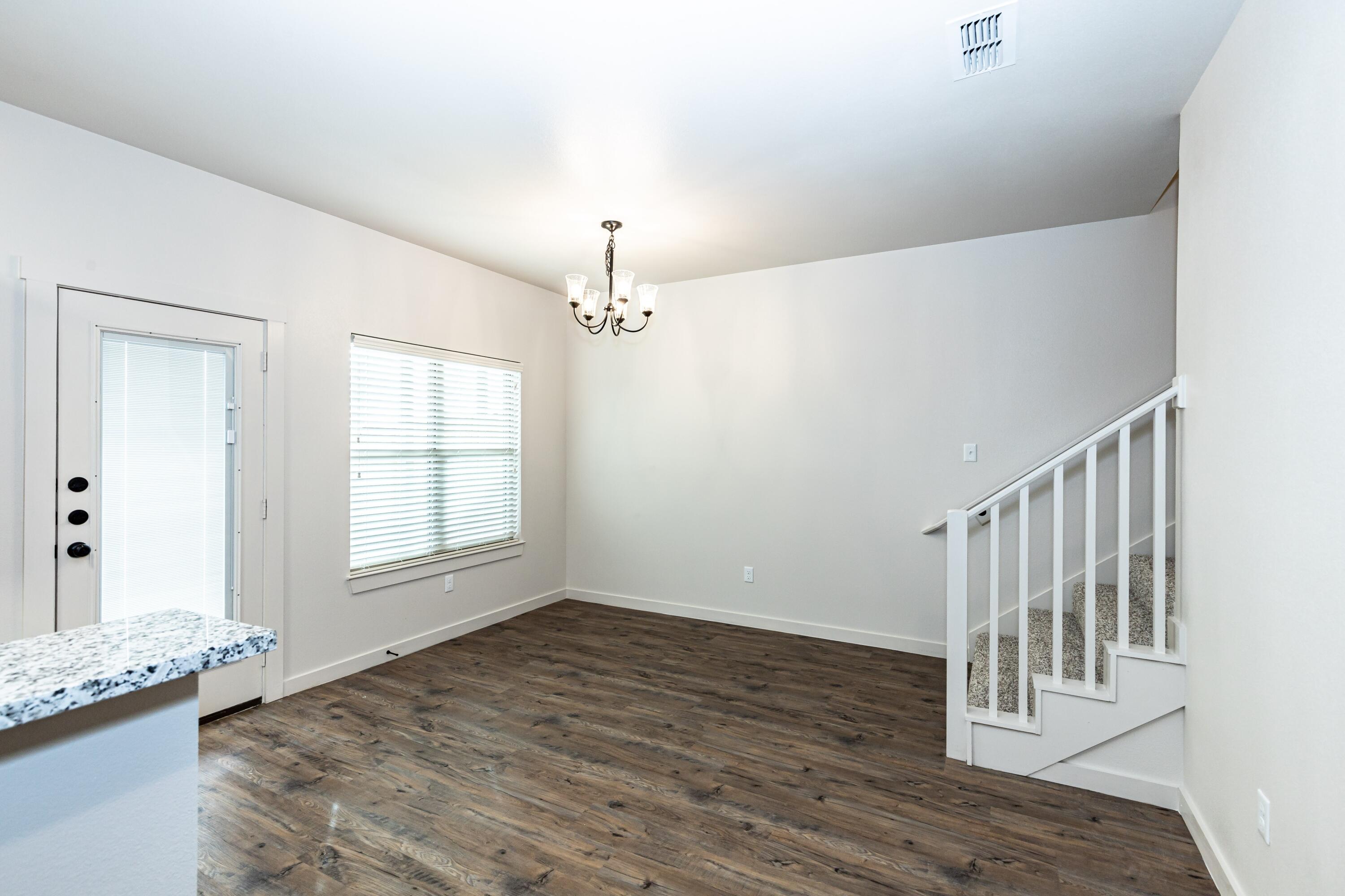 2529 138th Street Lubbock, TX 79423 - Photo 12 of 24 a view of livingroom with hardwood floor and hallway