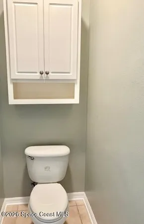 a bathroom with a toilet and a window