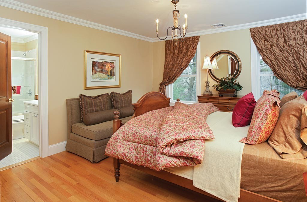 342 Woodland Road Brookline, MA 02467 - Photo 11 of 15 a bedroom with bed and a chandelier