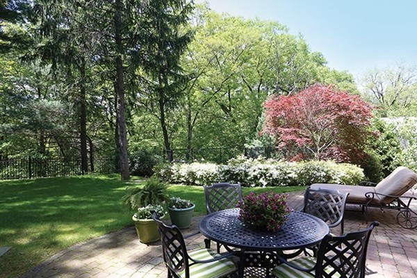 342 Woodland Road Brookline, MA 02467 - Photo 14 of 15 a table and chairs in a garden