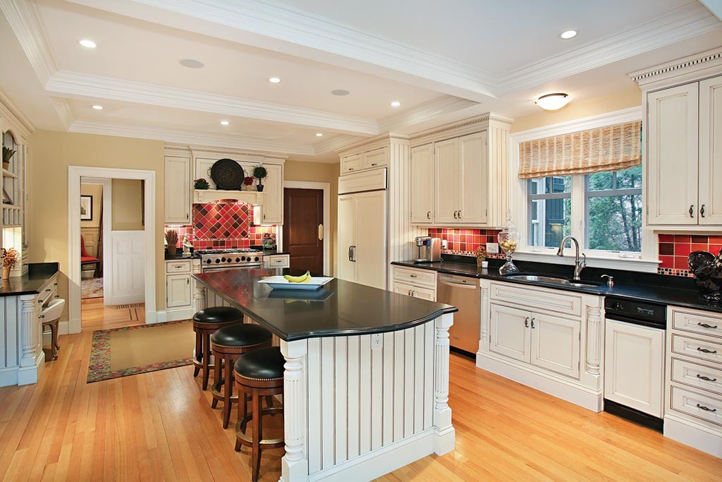 342 Woodland Road Brookline, MA 02467 - Photo 6 of 15 a kitchen with stainless steel appliances granite countertop a sink dishwasher a stove and a refrigerator with wooden floor