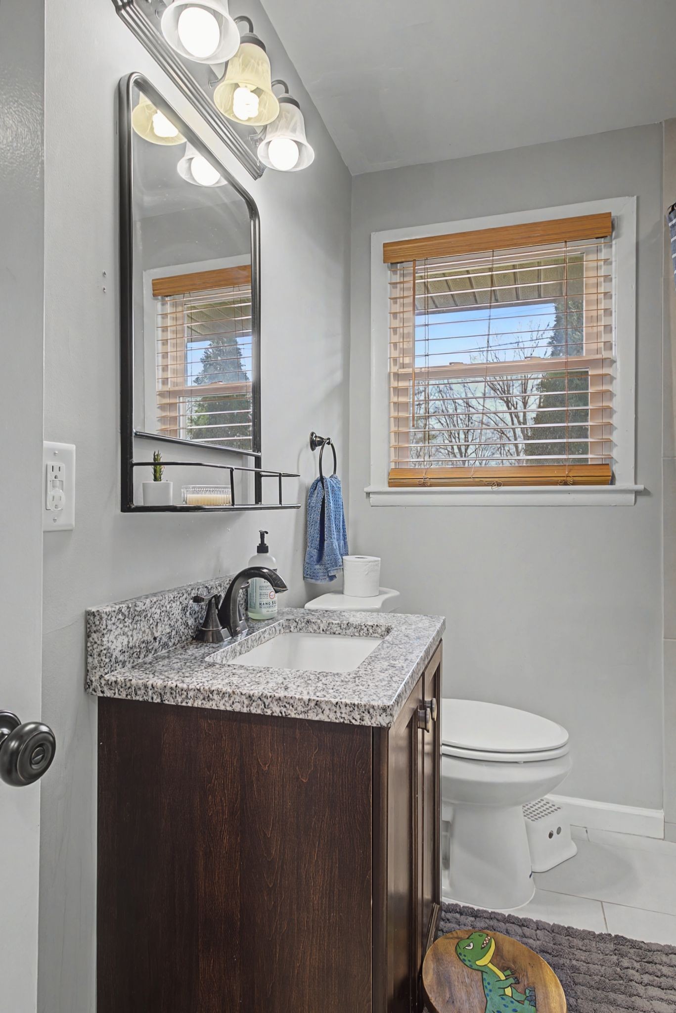 820 Allen Road Nashville, TN 37214 - Photo 20 of 28 a bathroom with a granite countertop toilet a sink a mirror and a window