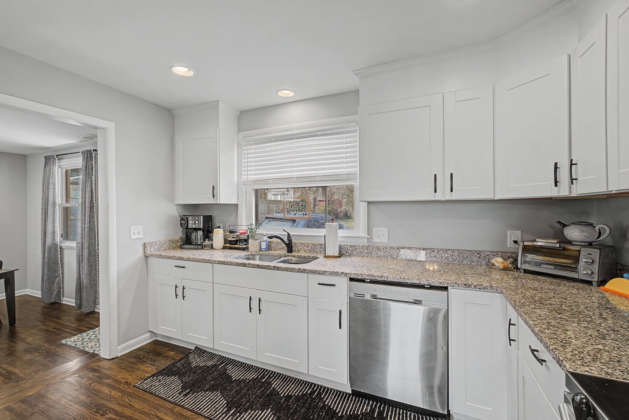 820 Allen Road Nashville, TN 37214 - Photo 9 of 28 a kitchen with white cabinets sink and stove