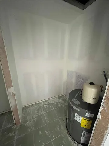 a living room with furniture and painting on the wall