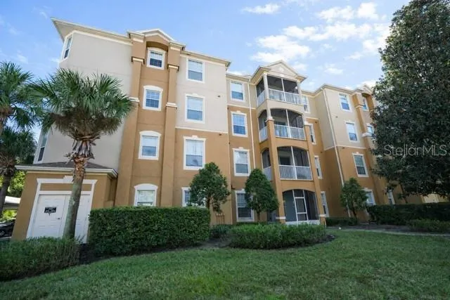 a front view of a residential apartment building with a yard