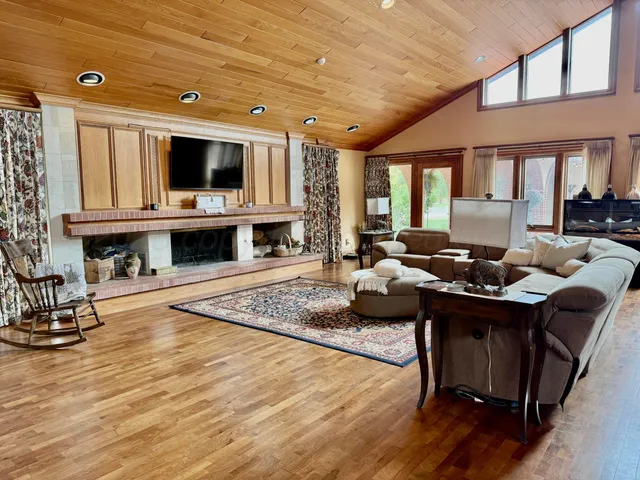 a living room with furniture flat screen tv and kitchen view