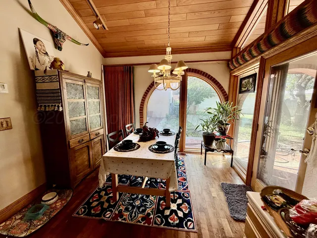 a living room with windows and wooden floor