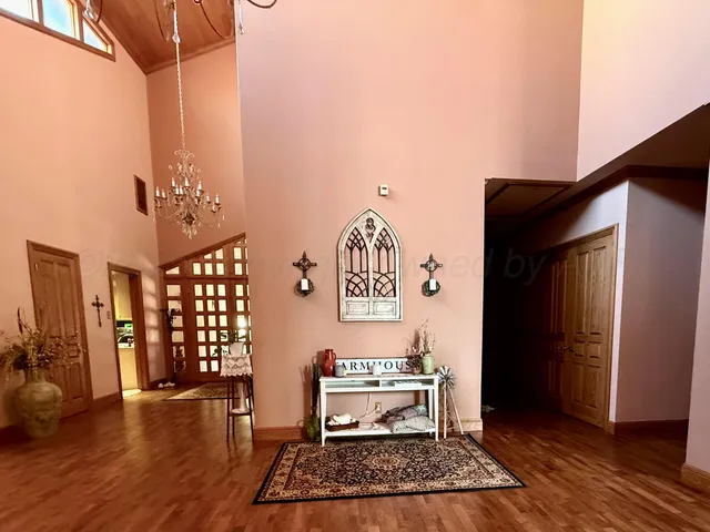 a room with lots of furniture and view of kitchen