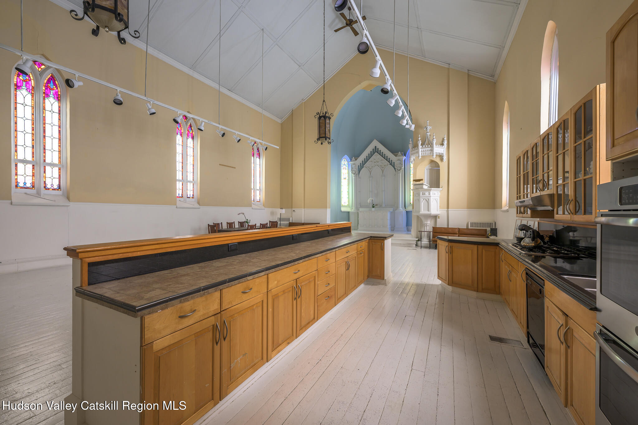428 State Street Hudson, NY 12534 - Photo 11 of 23 a kitchen with stainless steel appliances sink stove top oven and cabinets