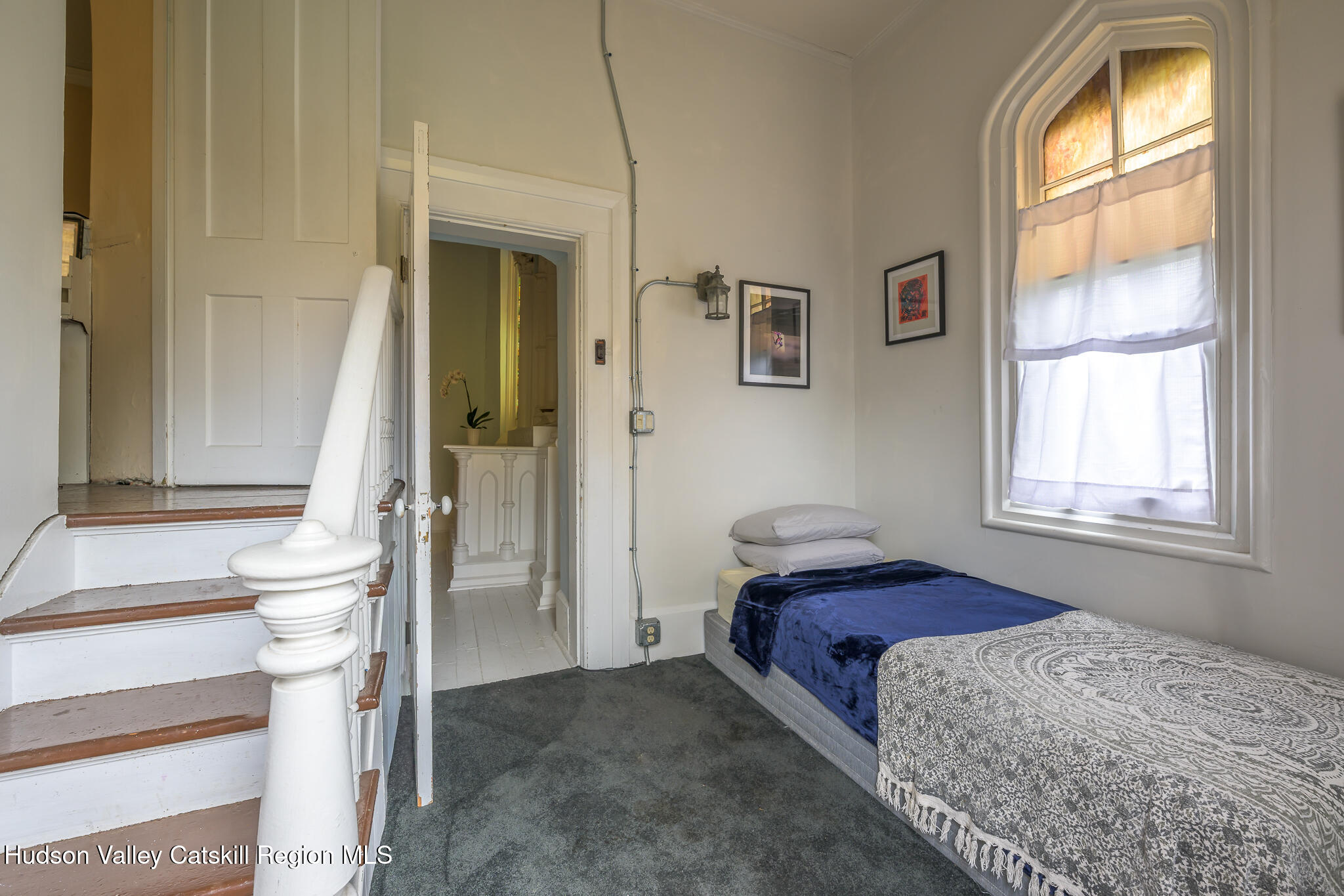428 State Street Hudson, NY 12534 - Photo 14 of 23 a bedroom with a bed and a window