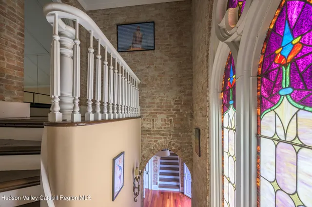 a view of a hallway to a livingroom with furniture