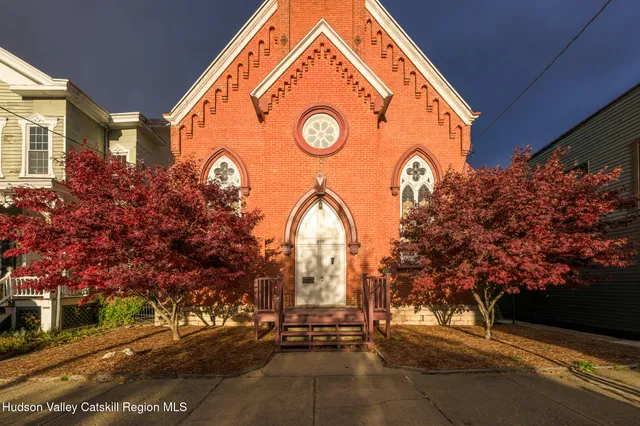 a view of a house with a yard and garage