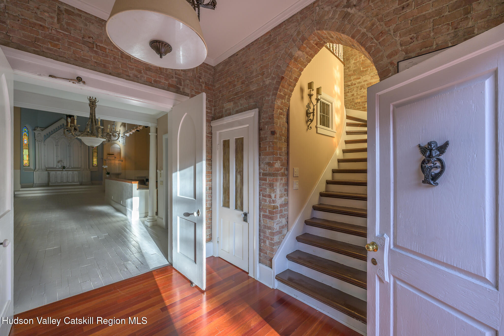 428 State Street Hudson, NY 12534 - Photo 6 of 23 a view of a hallway with entryway wooden floor and front door