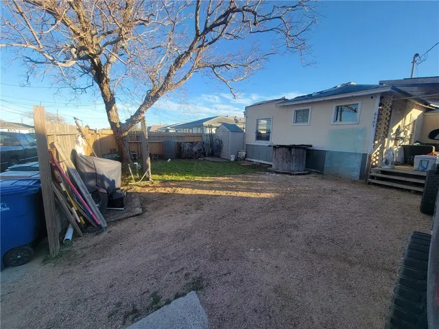 a view of a backyard with furniture and a garage