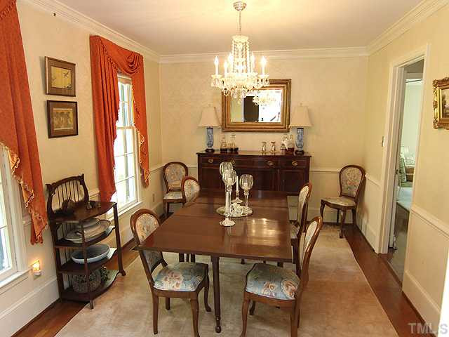 12209 Old Creedmoor Road Raleigh, NC 27613 - Photo 7 of 24 Spacious and bright formal dining room with chair rail, hardwood floors and neutral colors. Dining Room