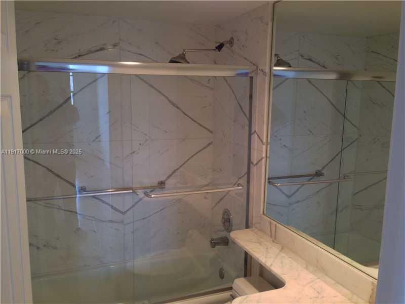 199 Ocean Ln Drive, Unit 1209 Key Biscayne, FL 33149 - Photo 6 of 10 a bathroom with a bathtub and a shower