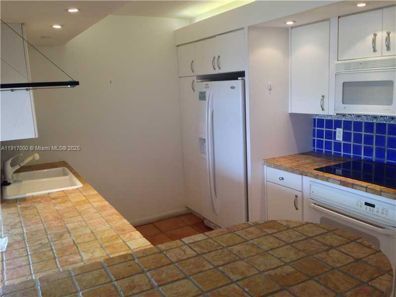199 Ocean Ln Drive, Unit 1209 Key Biscayne, FL 33149 - Photo 9 of 10 a kitchen with granite countertop a sink and a stove