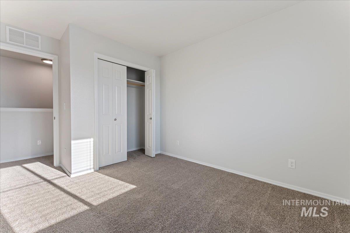 926 West Woodpine Street Meridian, ID 83646 - Photo 19 of 32 Unfurnished bedroom with carpet floors and a closet