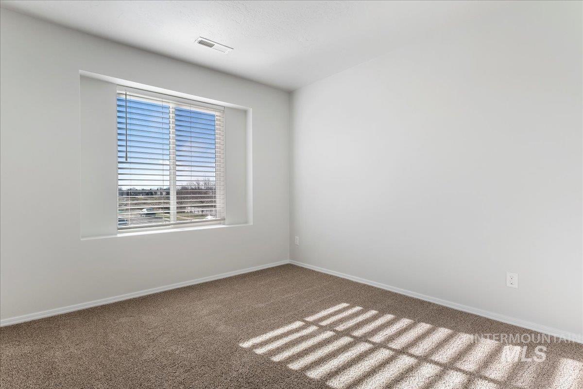 926 West Woodpine Street Meridian, ID 83646 - Photo 21 of 32 Carpeted spare room featuring baseboards