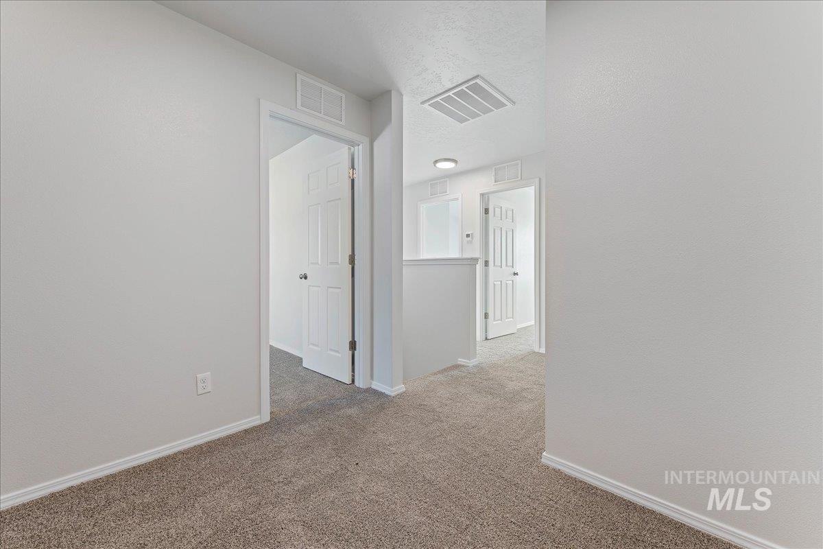 926 West Woodpine Street Meridian, ID 83646 - Photo 23 of 32 Corridor with carpet floors and a textured ceiling
