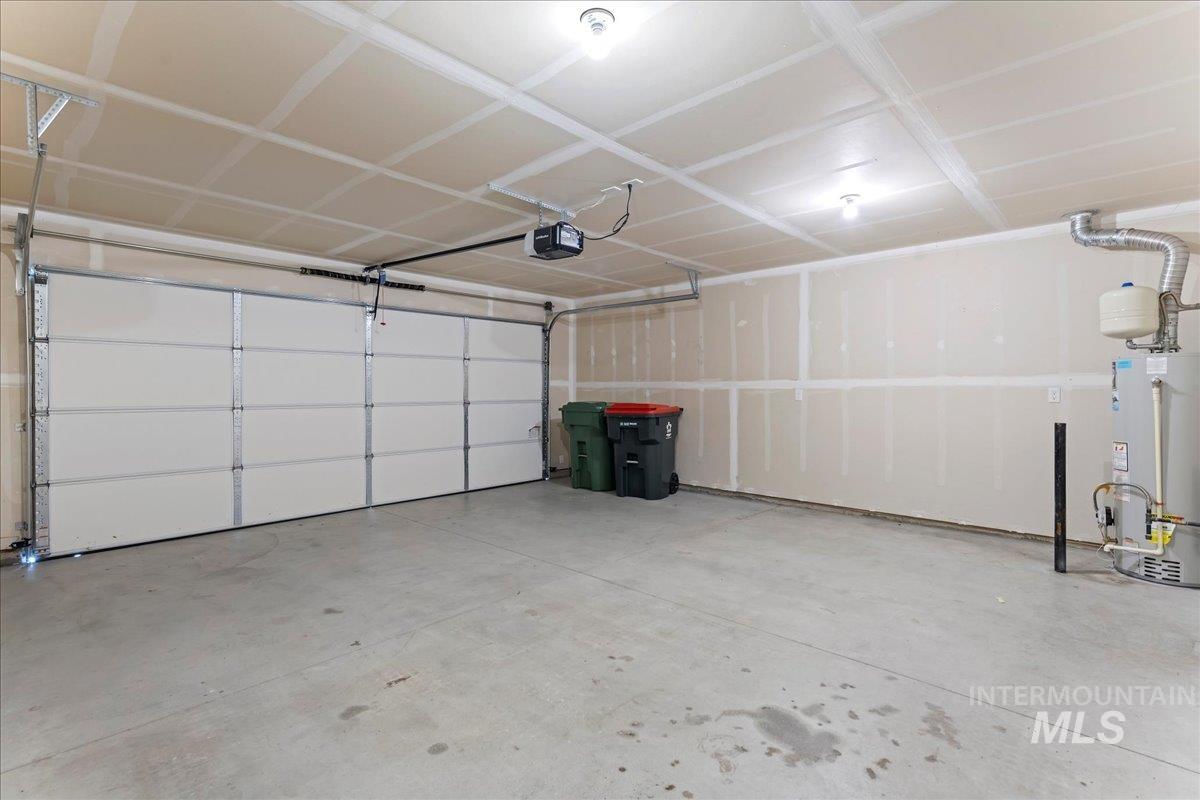 926 West Woodpine Street Meridian, ID 83646 - Photo 27 of 32 Garage featuring water heater and a garage door opener