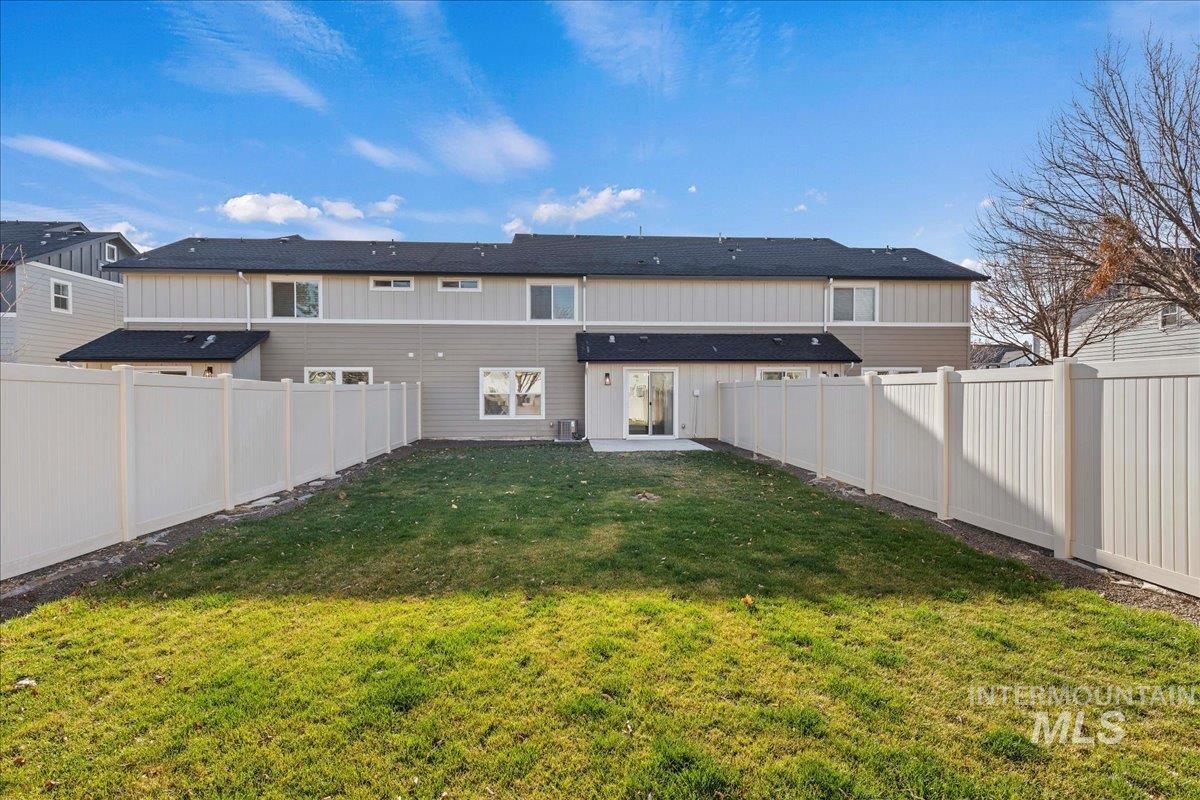 926 West Woodpine Street Meridian, ID 83646 - Photo 29 of 32 Back of property featuring a fenced backyard, a patio, and board and batten siding
