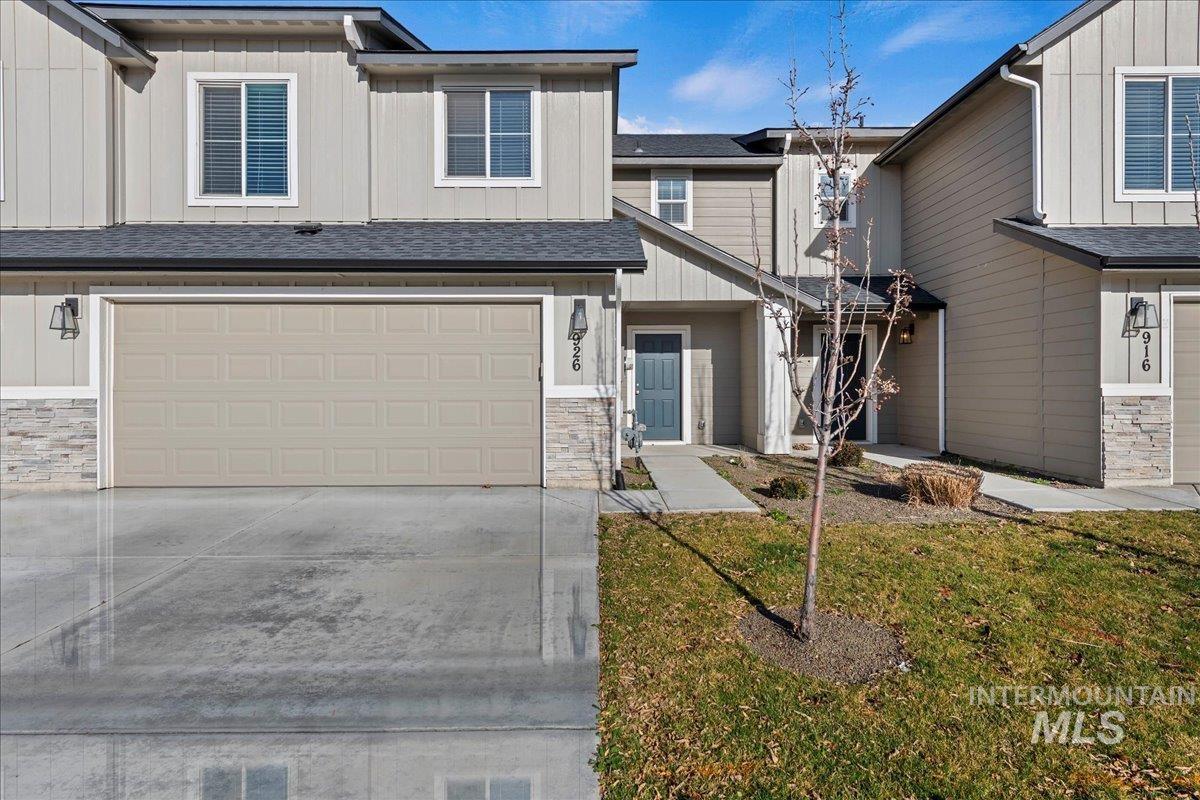 926 West Woodpine Street Meridian, ID 83646 - Photo 3 of 32 Craftsman-style home featuring stone siding, board and batten siding, a front lawn, driveway, and a garage