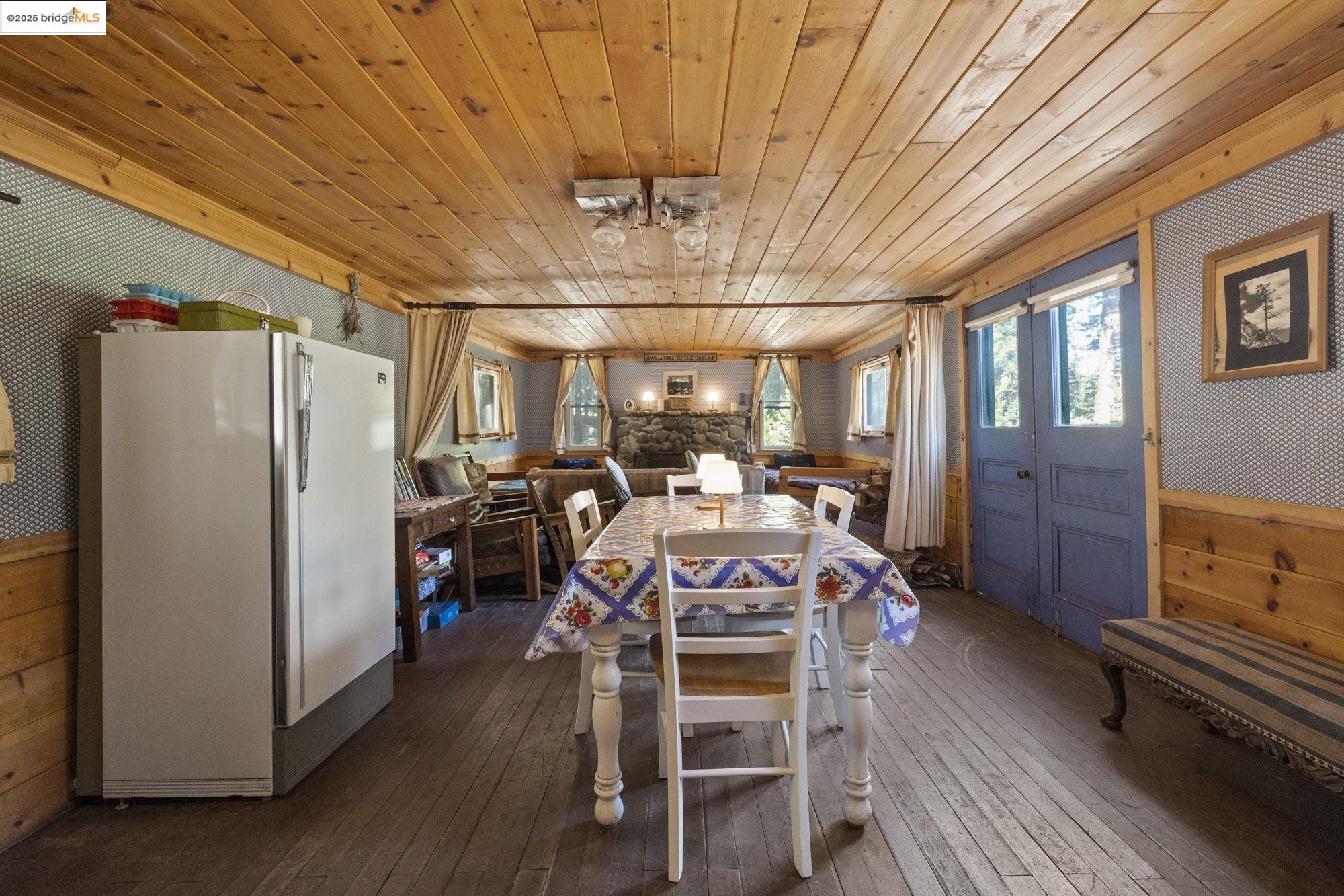 7 Riverside Tract Kyburz, CA 95720 - Photo 7 of 36 a view of a dining room with furniture window and wooden floor