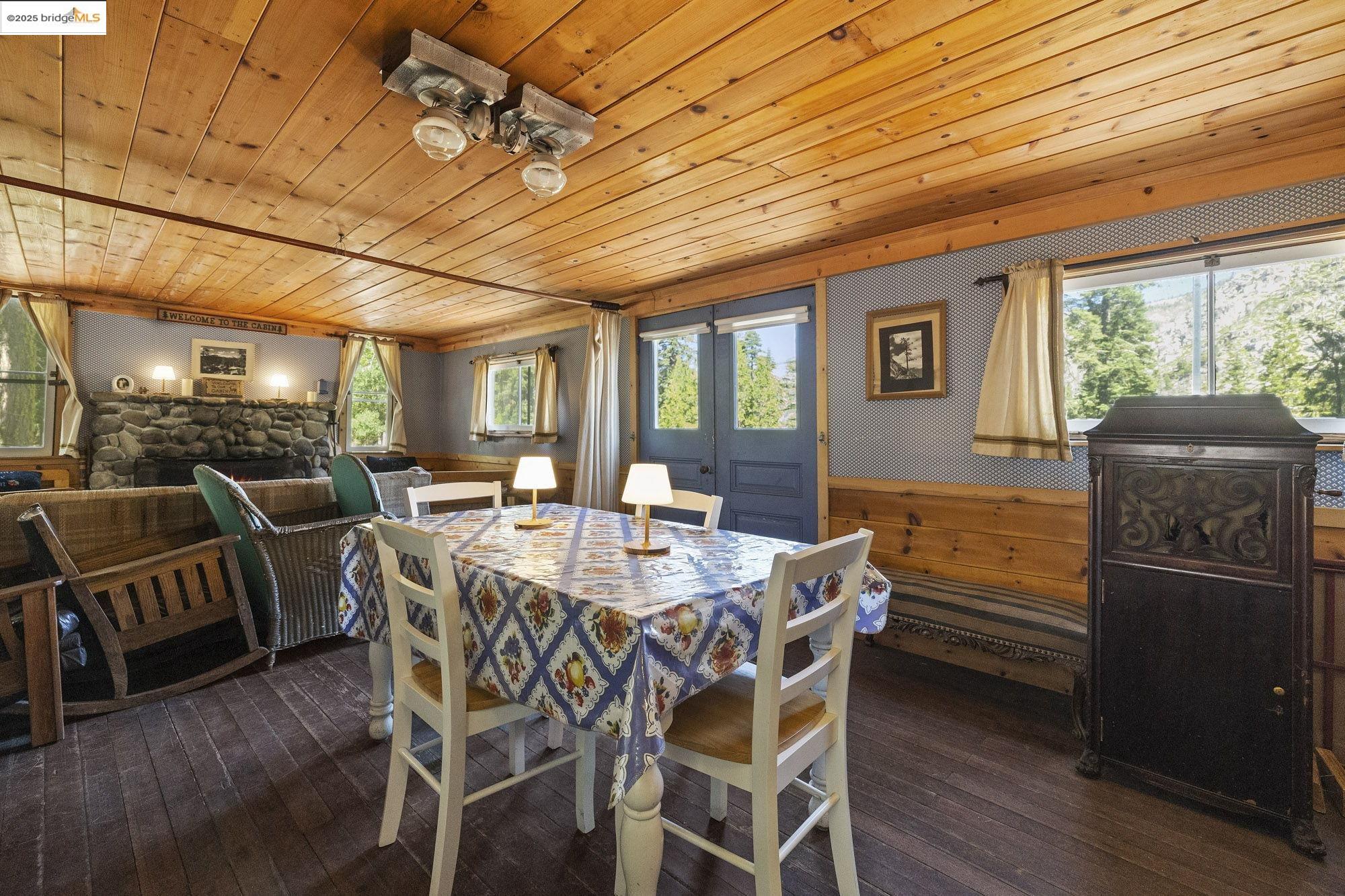 7 Riverside Tract Kyburz, CA 95720 - Photo 8 of 36 a view of a dining room with furniture window and wooden floor